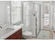 Bathroom showcasing a glass shower, vanity with modern fixtures, and natural light at 7533 Dunbridge Dr, Odessa, FL 33556