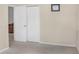 Bright and airy empty room with carpet flooring and bi-fold doors leading to another space at 7533 Dunbridge Dr, Odessa, FL 33556