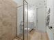 Bright bathroom featuring a tiled shower with glass door, modern vanity, and stylish decor at 7934 Lakes Edge Ln, Port Charlotte, FL 33981