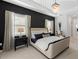 A bedroom featuring a tray ceiling, modern chandelier, and contemporary furnishings and decor at 7934 Lakes Edge Ln, Port Charlotte, FL 33981