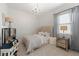 Charming bedroom features soft lighting, patterned wallpaper, and neutral color palette at 7934 Lakes Edge Ln, Port Charlotte, FL 33981