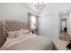Bright bedroom with tufted headboard, mirrored nightstand, and large closet at 7934 Lakes Edge Ln, Port Charlotte, FL 33981