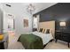 This bedroom has a dark accent wall, neutral bedding, and geometric lighting at 7934 Lakes Edge Ln, Port Charlotte, FL 33981