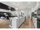 Beautiful kitchen featuring white cabinets, large island with sink, and stainless steel appliances at 7934 Lakes Edge Ln, Port Charlotte, FL 33981