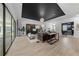 Open-concept living room with sliding glass doors, modern furnishings, and wood-look tile floors at 7934 Lakes Edge Ln, Port Charlotte, FL 33981