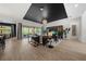 Bright living room showcasing the black accent ceiling, wood-look floors, and natural light at 7934 Lakes Edge Ln, Port Charlotte, FL 33981