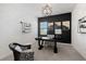 Home office featuring stylish desk, modern art, and geometric light fixture at 7934 Lakes Edge Ln, Port Charlotte, FL 33981