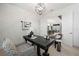 This home office has a contemporary desk, stylish chair, and updated lighting at 7934 Lakes Edge Ln, Port Charlotte, FL 33981