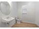 Modern powder room with patterned wall, sleek vanity, and neutral color palette at 7934 Lakes Edge Ln, Port Charlotte, FL 33981
