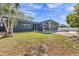 Exterior view of the home featuring a well-maintained lawn, and modern architecture at 8040 Owl Rd, Seminole, FL 33777