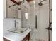 Modern bathroom featuring glass shower, stylish vessel sink, and updated fixtures at 8040 Owl Rd, Seminole, FL 33777