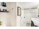 Clean bathroom with a marble-walled shower, a dark vanity, and tiled floors at 8341 Moulton Dr, Port Richey, FL 34668