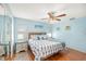 Relaxing bedroom with wooden floors, a decorative headboard, and a ceiling fan at 8341 Moulton Dr, Port Richey, FL 34668
