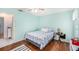 Cozy bedroom with wood floors and blue walls at 8341 Moulton Dr, Port Richey, FL 34668