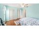 Bedroom with wood floors, ceiling fan, closet, nautical theme, and lots of natural light at 8341 Moulton Dr, Port Richey, FL 34668