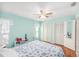 Bright bedroom with blue walls, ceiling fan, and two closets for ample storage space at 8341 Moulton Dr, Port Richey, FL 34668