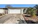 Charming single-story home with a well-manicured lawn and an attached two-car garage at 8341 Moulton Dr, Port Richey, FL 34668