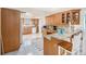 Spacious kitchen with granite countertops, custom cabinetry, and tile flooring at 8341 Moulton Dr, Port Richey, FL 34668