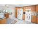 Spacious kitchen with stainless appliances and views into the living room with tile floors at 8341 Moulton Dr, Port Richey, FL 34668