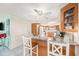 Kitchen breakfast bar features granite countertops, seating and views into the living room at 8341 Moulton Dr, Port Richey, FL 34668