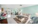 Spacious living room featuring cool-toned walls, tile flooring, and comfortable seating at 8341 Moulton Dr, Port Richey, FL 34668