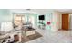 Inviting living area with stylish furnishings, cool wall color, and tile flooring at 8341 Moulton Dr, Port Richey, FL 34668