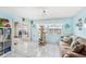 Comfortable living room featuring a cozy sofa, natural light, and a unique cat climbing tree at 8341 Moulton Dr, Port Richey, FL 34668