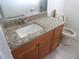 Bathroom with tiled floors, single sink vanity, framed mirror, and toilet at 9038 Walsingham Rd, Largo, FL 33773