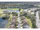 Picturesque aerial view of a neighborhood with houses surrounding a pond and a golf course at 988 Villeroy Greens Dr, Sun City Center, FL 33573