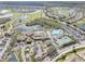 Wide aerial shot of the resort showing a large swimming pool, lakes, and golf course at 988 Villeroy Greens Dr, Sun City Center, FL 33573