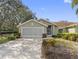 Charming one-story home featuring a two-car garage, well-maintained landscaping, and a cozy entrance at 988 Villeroy Greens Dr, Sun City Center, FL 33573