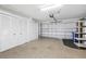 Spacious garage with epoxy flooring, ample storage, and an automatic door opener at 988 Villeroy Greens Dr, Sun City Center, FL 33573