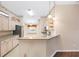 Kitchen features granite countertops, stainless steel refrigerator, and light wood cabinets at 988 Villeroy Greens Dr, Sun City Center, FL 33573