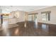 Bright living room features wood floors, ceiling fans, and sliding glass doors to the sunroom at 988 Villeroy Greens Dr, Sun City Center, FL 33573