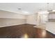 Spacious living room featuring wood floors, neutral paint, and two ceiling fans at 988 Villeroy Greens Dr, Sun City Center, FL 33573