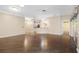 Spacious living room boasts wood floors, ceiling fans, and natural light from the large windows at 988 Villeroy Greens Dr, Sun City Center, FL 33573