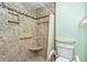 Accessible shower featuring grab bars, built-in seat, and a handheld shower head for convenience at 988 Villeroy Greens Dr, Sun City Center, FL 33573