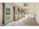 Sunroom offers tile floor, ceiling fan, and large windows providing great views of the backyard at 988 Villeroy Greens Dr, Sun City Center, FL 33573