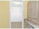 Walk-in closet with wire shelving for optimal storage, conveniently located near bathroom at 988 Villeroy Greens Dr, Sun City Center, FL 33573