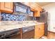 Galley kitchen featuring granite countertops, stainless steel appliances, and decorative backsplash at 100 4Th S Ave # 109, St Petersburg, FL 33701