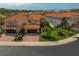 Aerial view of a two-story home with a red tile roof and well-manicured lawn at 10136 Grand Oak Cir, Madeira Beach, FL 33708