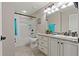 Neutral bathroom with granite counters, a combination tub and shower, and ample lighting at 10136 Grand Oak Cir, Madeira Beach, FL 33708