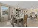 Dining room with natural lighting and modern light fixture attached to the kitchen at 10136 Grand Oak Cir, Madeira Beach, FL 33708