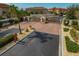 Gated community entrance featuring brick-paved roundabout and lush tropical landscaping at 10136 Grand Oak Cir, Madeira Beach, FL 33708