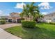 Charming two-story home featuring a three car garage and landscaped yard at 10136 Grand Oak Cir, Madeira Beach, FL 33708