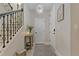 Hallway showcasing an elegant light fixture, stylish decor, and staircase detail at 10136 Grand Oak Cir, Madeira Beach, FL 33708