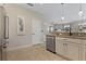 Open kitchen area featuring granite counters, stainless dishwasher, and view into the living room at 10136 Grand Oak Cir, Madeira Beach, FL 33708