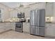 Well-lit kitchen with stainless steel appliances, granite countertops, and decorative accents at 10136 Grand Oak Cir, Madeira Beach, FL 33708