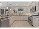 Modern kitchen featuring granite countertops, stainless steel appliances, and tile flooring at 10136 Grand Oak Cir, Madeira Beach, FL 33708
