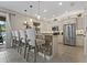Open concept kitchen with counter seating, stainless appliances, and pendant lighting at 10136 Grand Oak Cir, Madeira Beach, FL 33708